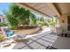 Relaxing covered patio area with comfortable seating, perfect for enjoying the outdoor space and landscaped backyard at 15134 W Waterford Dr, Surprise, AZ 85374