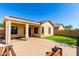 Home backyard featuring a covered patio with concrete pillars, artificial grass, and a fence at 152 N 194Th Ln, Buckeye, AZ 85326