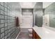 Bathroom with patterned accent wall, features tub-shower combination, and modern fixtures, creating a clean and inviting space at 152 N 194Th Ln, Buckeye, AZ 85326