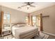 Bright bedroom featuring contemporary decor, a ceiling fan, and natural light at 152 N 194Th Ln, Buckeye, AZ 85326