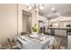 Breakfast nook featuring a modern chandelier with kitchen view in a well-lit home at 152 N 194Th Ln, Buckeye, AZ 85326