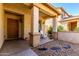 Inviting front porch with decorative columns and desert landscaping at 152 N 194Th Ln, Buckeye, AZ 85326