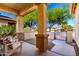 Cozy front porch with seating, decorative columns, and gated entry at 152 N 194Th Ln, Buckeye, AZ 85326