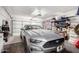 Garage featuring a modern convertible, multiple doors, shelving, and overhead storage at 152 N 194Th Ln, Buckeye, AZ 85326