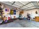 Spacious garage featuring an empty interior space with side shelving and overhead garage door at 152 N 194Th Ln, Buckeye, AZ 85326