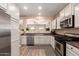 Kitchen featuring stainless steel appliances, white cabinets, and open layout at 152 N 194Th Ln, Buckeye, AZ 85326
