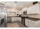 Kitchen featuring stainless steel appliances, white cabinets, and view to the Gathering room at 152 N 194Th Ln, Buckeye, AZ 85326