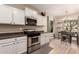 Bright kitchen and breakfast nook with stainless steel appliances and white cabinetry at 152 N 194Th Ln, Buckeye, AZ 85326