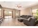 Living room featuring wood floors, a ceiling fan, and a sliding glass door to the patio at 152 N 194Th Ln, Buckeye, AZ 85326
