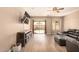 Spacious living room with wood floors, ceiling fan and sliding door access to the backyard at 152 N 194Th Ln, Buckeye, AZ 85326