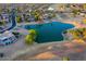 Expansive aerial view of a residential community with a large pond, golf course, and picturesque landscaping at 15766 W Grand Point Ln, Surprise, AZ 85374
