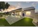 Relaxing backyard with covered patio, desert landscaping, and paver patio at 15766 W Grand Point Ln, Surprise, AZ 85374