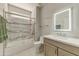 Bathroom with a white vanity and a glass-enclosed shower at 15766 W Grand Point Ln, Surprise, AZ 85374