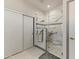 Bathroom featuring an updated glass enclosed shower with marble tile and brushed gold hardware at 15766 W Grand Point Ln, Surprise, AZ 85374