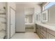 Bathroom with glass enclosed shower, marble tile, modern vanity and en suite bedroom at 15766 W Grand Point Ln, Surprise, AZ 85374