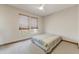 Cozy bedroom with large windows and a ceiling fan at 15766 W Grand Point Ln, Surprise, AZ 85374