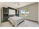 Bedroom featuring a custom murphy bed with built in cabinetry and a large window at 15766 W Grand Point Ln, Surprise, AZ 85374
