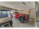 Garage with a red truck and a golf cart at 15766 W Grand Point Ln, Surprise, AZ 85374