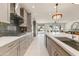 Stylish kitchen featuring stainless steel appliances, modern backsplash, and open access to living room at 15766 W Grand Point Ln, Surprise, AZ 85374
