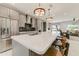 Modern kitchen with stainless steel appliances, quartz countertops, and an eat-in island at 15766 W Grand Point Ln, Surprise, AZ 85374