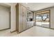 Modern kitchen with bar area including upper and lower cabinets and sliding door to outdoor space at 15766 W Grand Point Ln, Surprise, AZ 85374