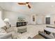 Spacious living room featuring a ceiling fan, comfortable seating, and entertainment center at 15766 W Grand Point Ln, Surprise, AZ 85374