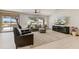 Bright living room featuring a ceiling fan, large windows with golf course views and modern decor at 15766 W Grand Point Ln, Surprise, AZ 85374