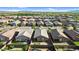Expansive aerial view of a neighborhood featuring single-Gathering homes, desert landscaping, and mountain views in the distance at 16396 W Questa Dr, Surprise, AZ 85387