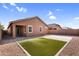 Well-maintained backyard with block wall fencing, artificial turf, gravel and patio at 16396 W Questa Dr, Surprise, AZ 85387