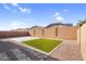 Spacious backyard with block wall fencing, artificial turf, pavers and gravel landscaping at 16396 W Questa Dr, Surprise, AZ 85387