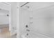 Bright bathroom features a white tiled shower/tub combination at 16396 W Questa Dr, Surprise, AZ 85387