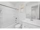 Clean bathroom featuring a white tiled shower/tub combination and a vanity at 16396 W Questa Dr, Surprise, AZ 85387