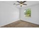 Bright bedroom has neutral carpet, a ceiling fan and a window with blinds at 16396 W Questa Dr, Surprise, AZ 85387