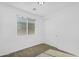 Bright bedroom features neutral carpet, a window with blinds and a closet with double doors at 16396 W Questa Dr, Surprise, AZ 85387