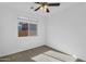 This bedroom features carpet, ceiling fan and one window for natural light at 16396 W Questa Dr, Surprise, AZ 85387