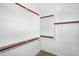Spacious walk-in closet with hanging racks, shelves, and carpeted floor at 16396 W Questa Dr, Surprise, AZ 85387