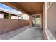 Covered patio featuring concrete flooring, slider door, and a view of the block wall fence at 16396 W Questa Dr, Surprise, AZ 85387