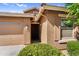 Close-up view of the front entrance, showing house number and decorative shrubbery at 16396 W Questa Dr, Surprise, AZ 85387