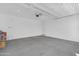 Clean, empty garage with concrete floors and a functional garage door at 16396 W Questa Dr, Surprise, AZ 85387