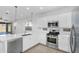 Bright, tiled kitchen features stainless steel appliances and a view to the backyard at 16396 W Questa Dr, Surprise, AZ 85387