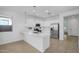 Stylish kitchen with white cabinetry, stainless steel appliances, and an island with bar seating at 16396 W Questa Dr, Surprise, AZ 85387