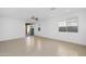 Spacious living room with neutral tile flooring, recessed lighting, and sliding glass doors to the backyard at 16396 W Questa Dr, Surprise, AZ 85387