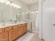 Bright bathroom with double sink vanity and glass-enclosed shower, offering a clean, modern aesthetic at 16603 N 168Th Dr, Surprise, AZ 85388