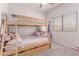 Comfortable bedroom with a wooden bunk bed and plush carpet, creating a kid-friendly atmosphere at 16603 N 168Th Dr, Surprise, AZ 85388