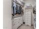 Well-organized walk-in closet with ample storage, drawers, and shelving for clothing and accessories at 16603 N 168Th Dr, Surprise, AZ 85388