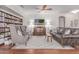 Cozy living room featuring built-in bookshelves, stylish seating, and a decorative ceiling fan at 16603 N 168Th Dr, Surprise, AZ 85388