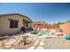 Charming backyard featuring a refreshing pool area with rock accents and ample patio space for outdoor enjoyment at 16924 W Stevenage St, Surprise, AZ 85374