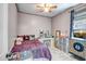 Unique bedroom with pink leopard sheets, a vanity, and a ceiling fan, creating a fun and personalized space at 16924 W Stevenage St, Surprise, AZ 85374