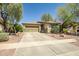 Charming single-story home featuring a well-manicured lawn, desert landscaping, and a spacious two-car garage at 16924 W Stevenage St, Surprise, AZ 85374