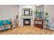 Charming fireplace area featuring stylish decor, plants, and wood-look floors, creating a cozy and inviting atmosphere at 16924 W Stevenage St, Surprise, AZ 85374